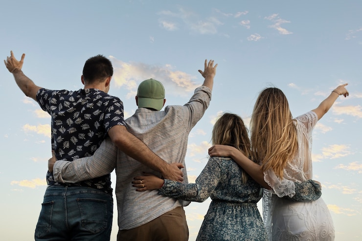 Friends togerther standing while wrapping each other from back