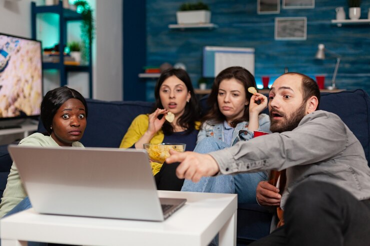 multi-ethnic-friends-spending-time-together-looking-entertainment-laptop-talking-about-tv series